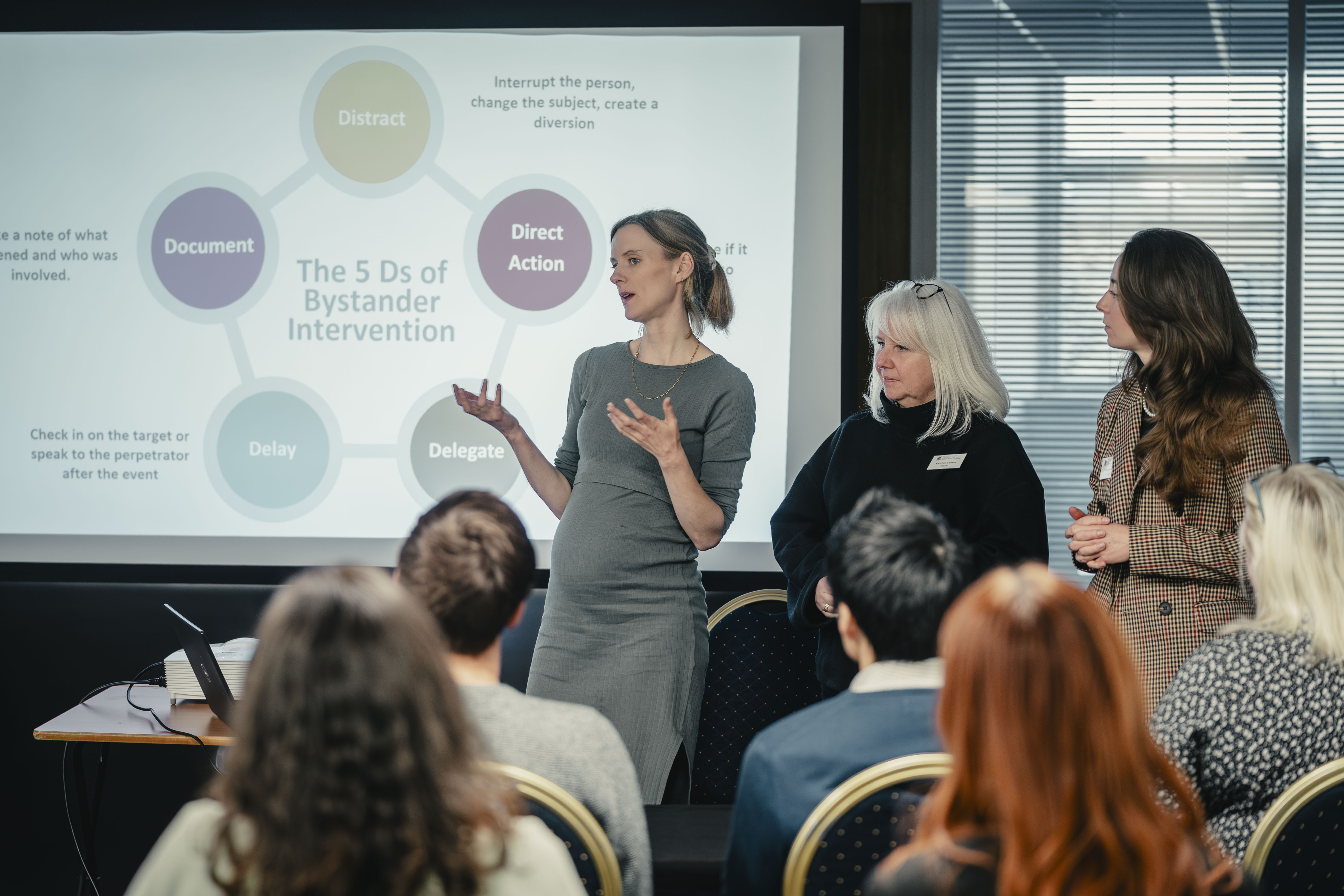 Three women presenting to a group